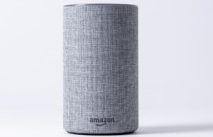 gray jbl portable speaker on white table